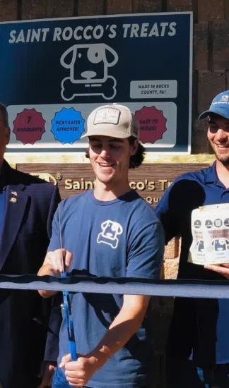 Kaleb Rush cuts the ribbon at the new Saint Rocco's Treats Hatfield facility on Oct. 21.
