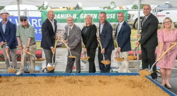Business executives break ground for senior living community.