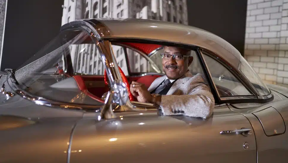Ed Welburn sits in his 1957 Corvette.