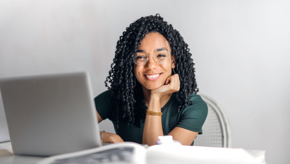 College student smiling with her laptop
