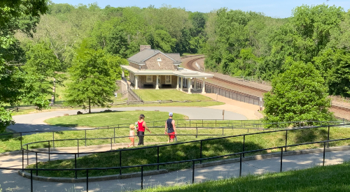 A family walks toward Valley Forge Train Station in Valley Forge park