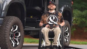 man in wheelchair getting non-profit assistance