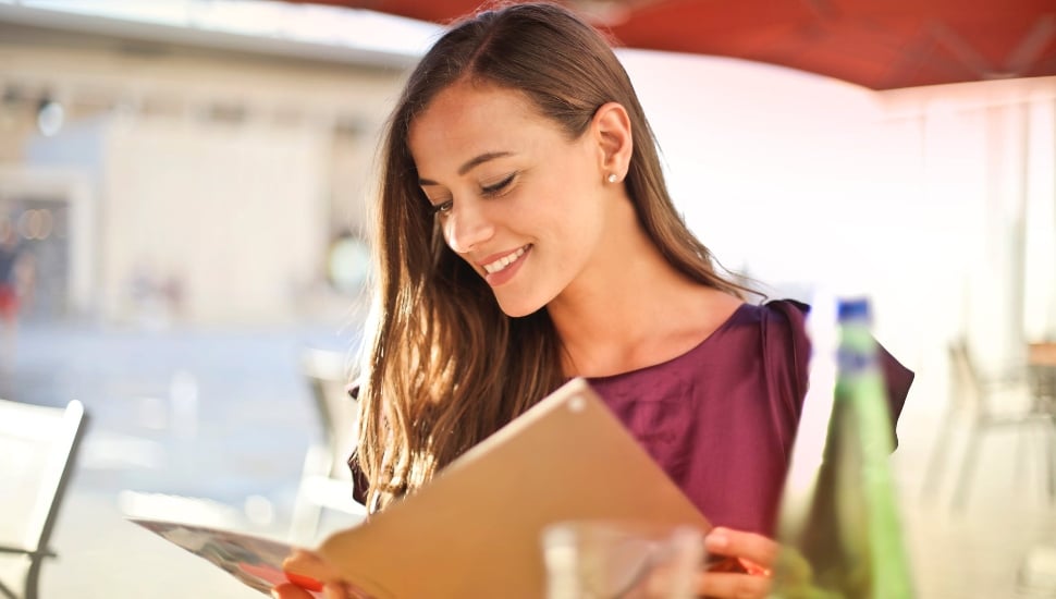 VFTCB visitor's guide dining girl with menu