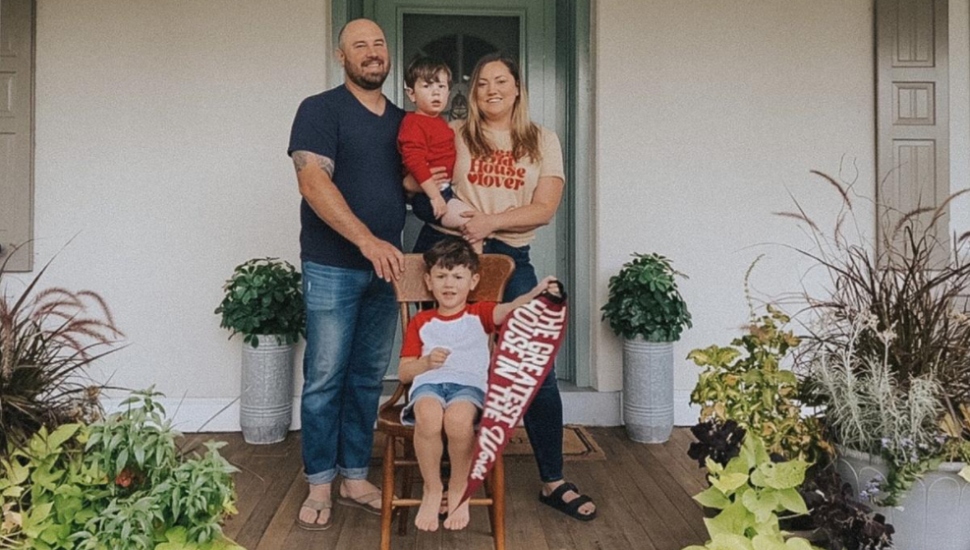 family on front of house
