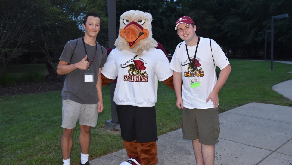 College students with Gwynedd Mercy University mascot