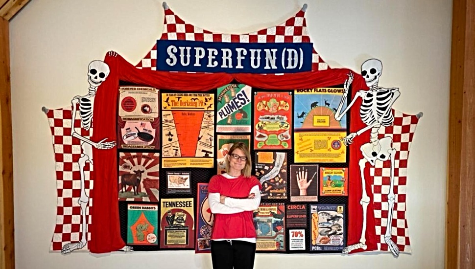 Artist Maggy Rozycki Hiltner, in from of her Superfund quilt.