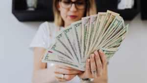 Accredited investor woman holding money