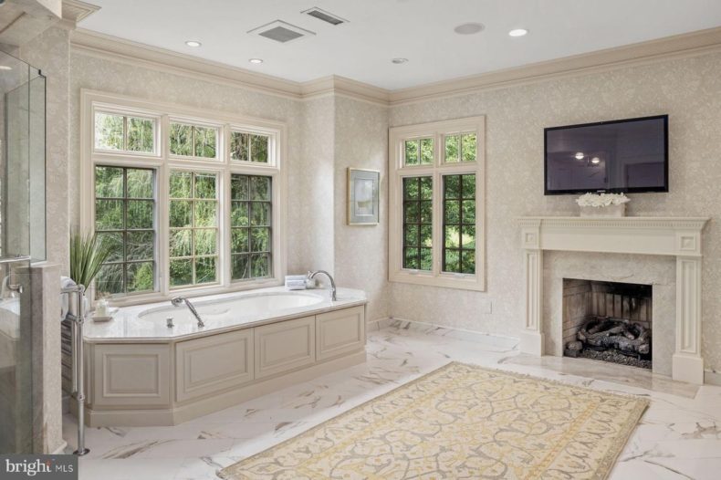 Master bathroom with soaking tub in manor house