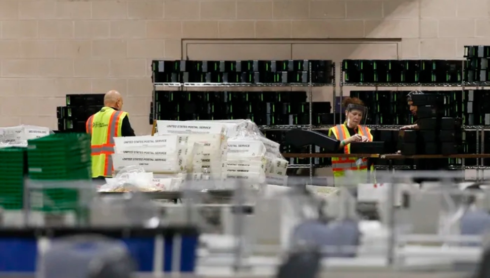 Workers with incorrectly printed mail ballots.
