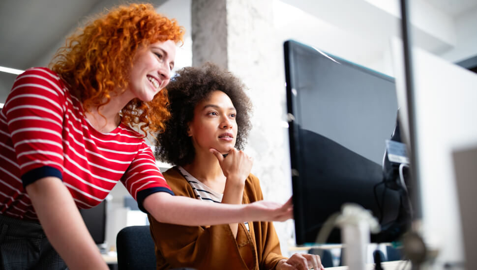 Two Women looking at a computer monitor