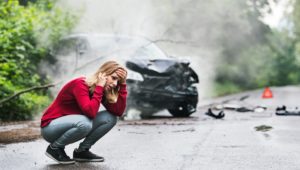 Woman making a call after a car accident