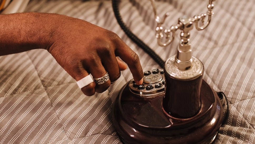 man dialing 215 area code