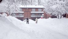 two men shoveling snow