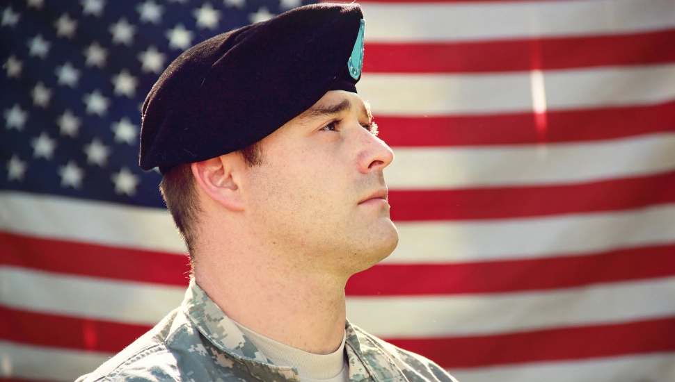 veteran in front of flag