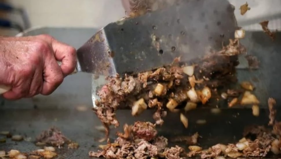 A cheesesteak on the grill