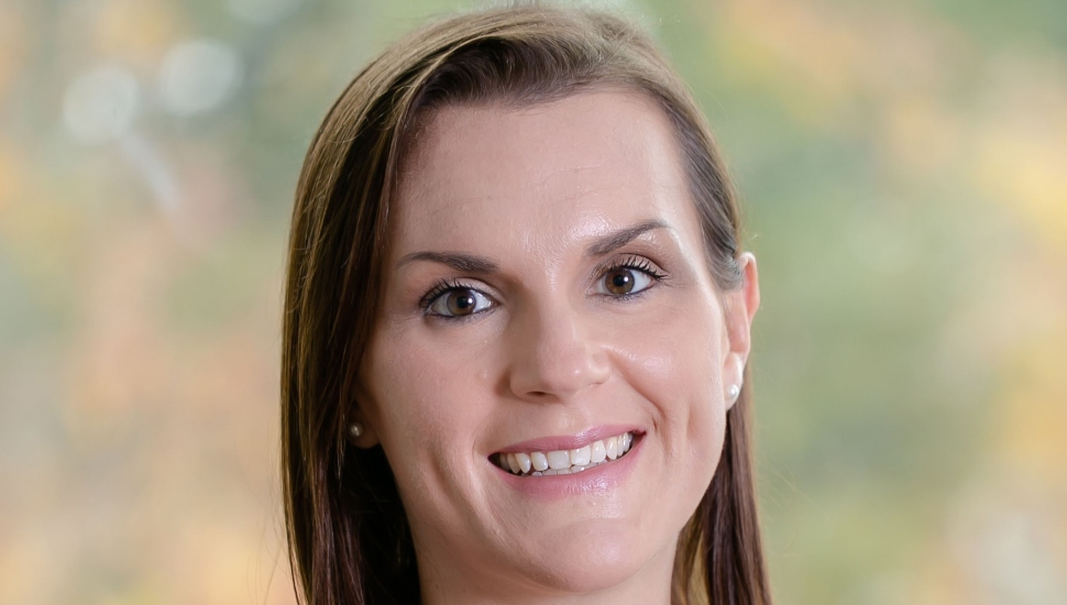 woman in white blouse and blue blazer