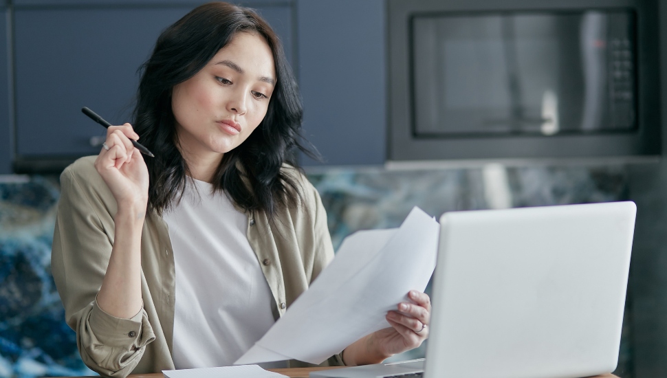 woman with a pen at a laptop