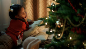 Little girl by a Christmas Tree