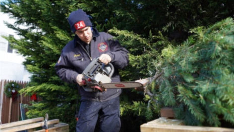 Volunteer Fire Fighter Cutting Christmas Trees