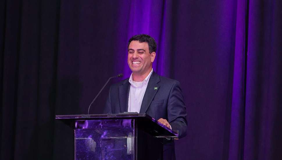 smiling man at podium