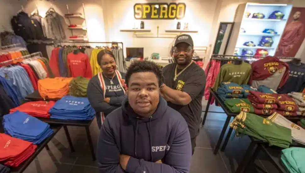 three people in a clothing shop