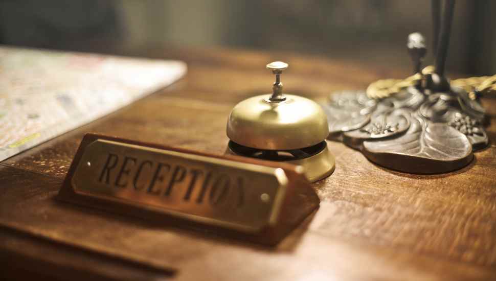 bell and sign on a desk