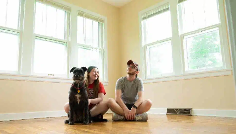 couple with a dog in a room