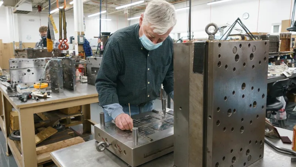 Man working on tool die.