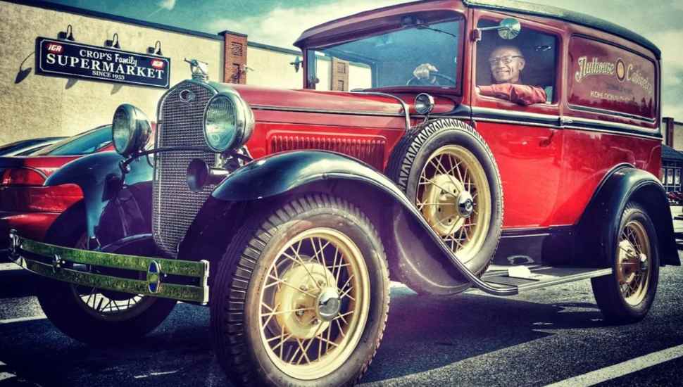 man in antique car