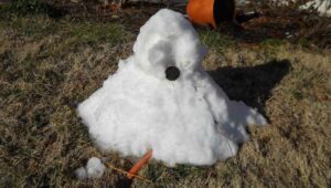 melted snowman in a yard