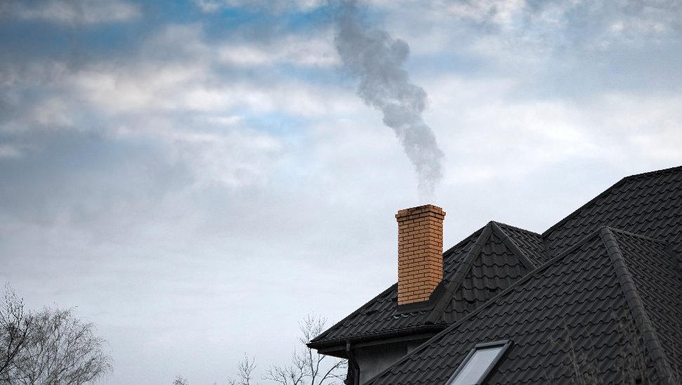 smoke from a brick chimney
