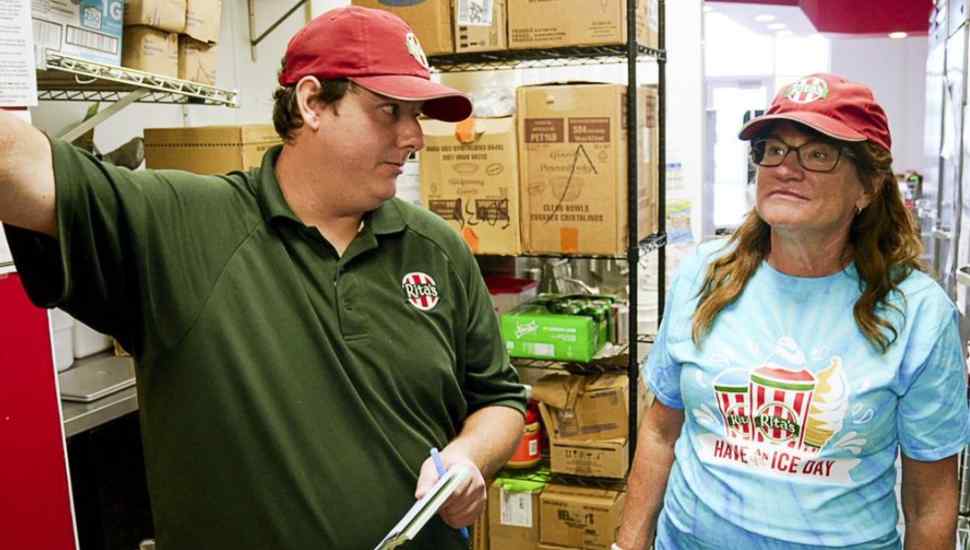 two employees wearing hats
