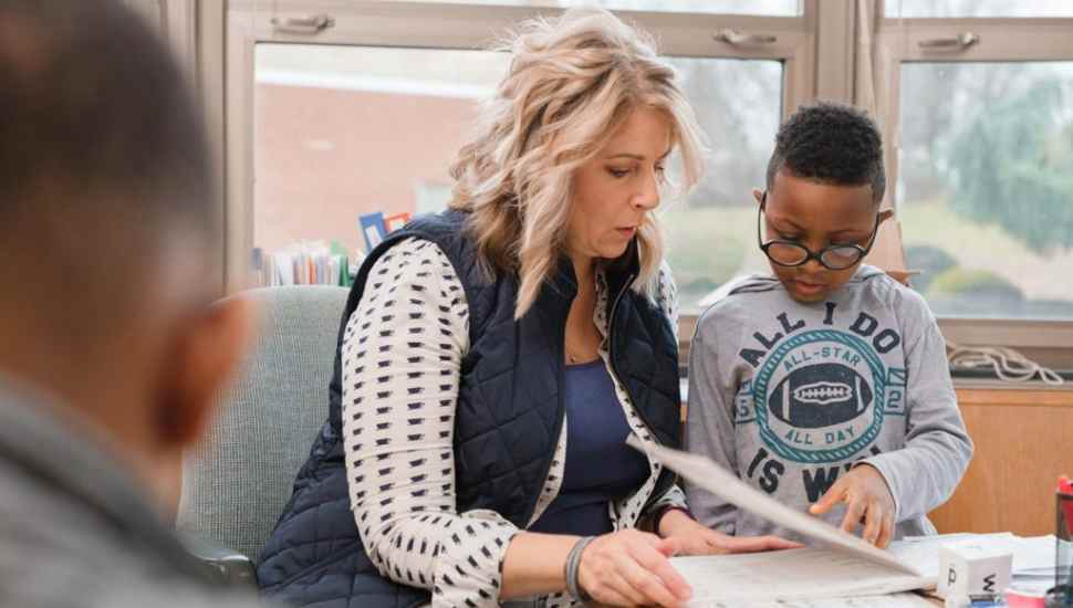 woman helping child