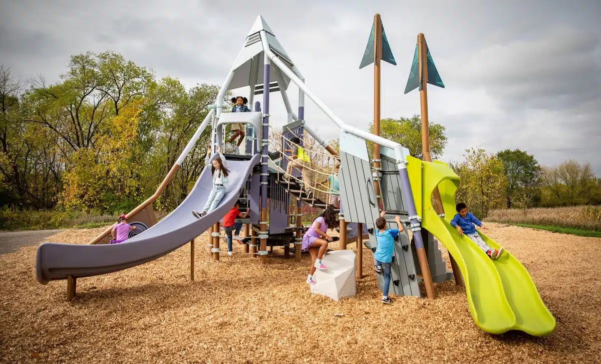 Kids playing on the Smart Play Summit play equipment.