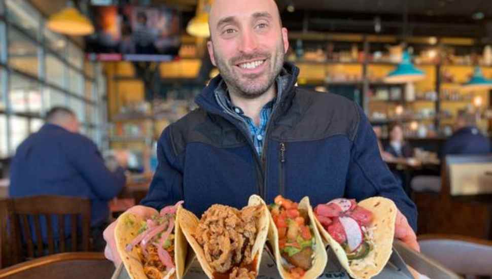 man with taco tray