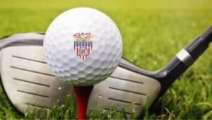 Golf club hitting a golf ball with the Valley Forge Military Academy and College logo.