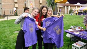 3 Women show off some West Chester University 150th anniversary T-shirts