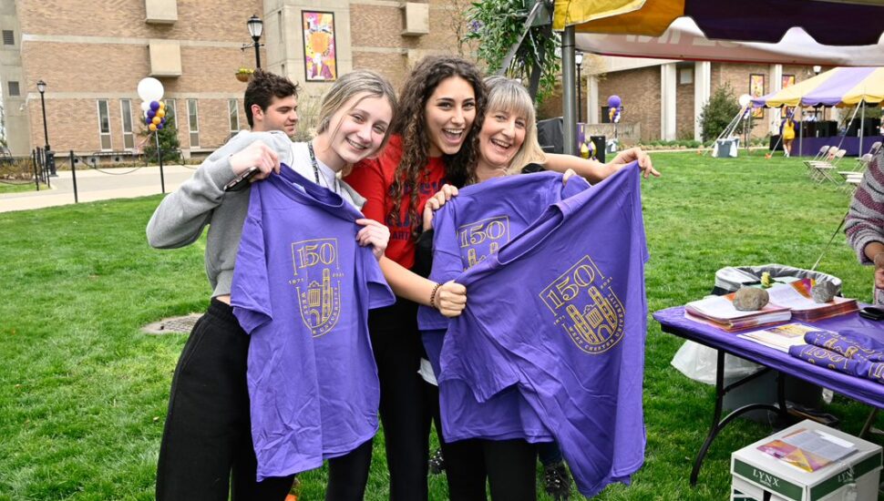 3 Women show off some West Chester University 150th anniversary T-shirts