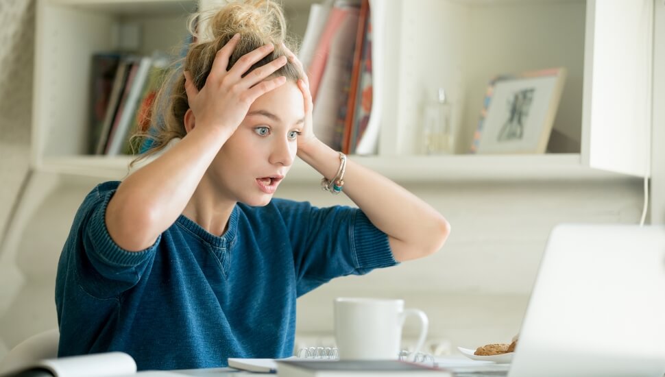 Young woman realizes her mistake at work