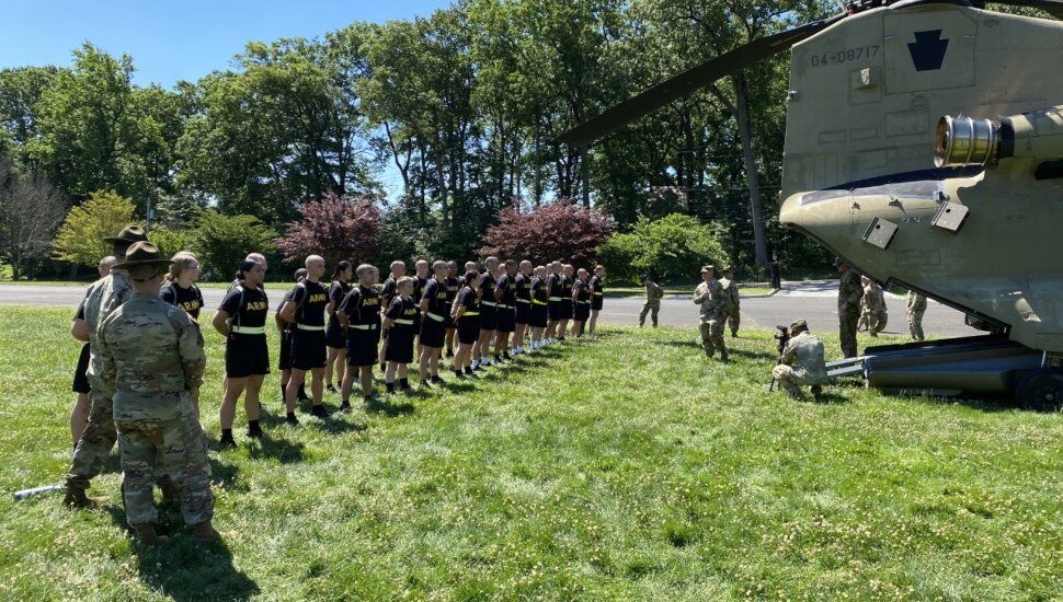 Valley Forge Military College students standing in a lineup outside a CH47 Chinook helicopter that has landed on campus.