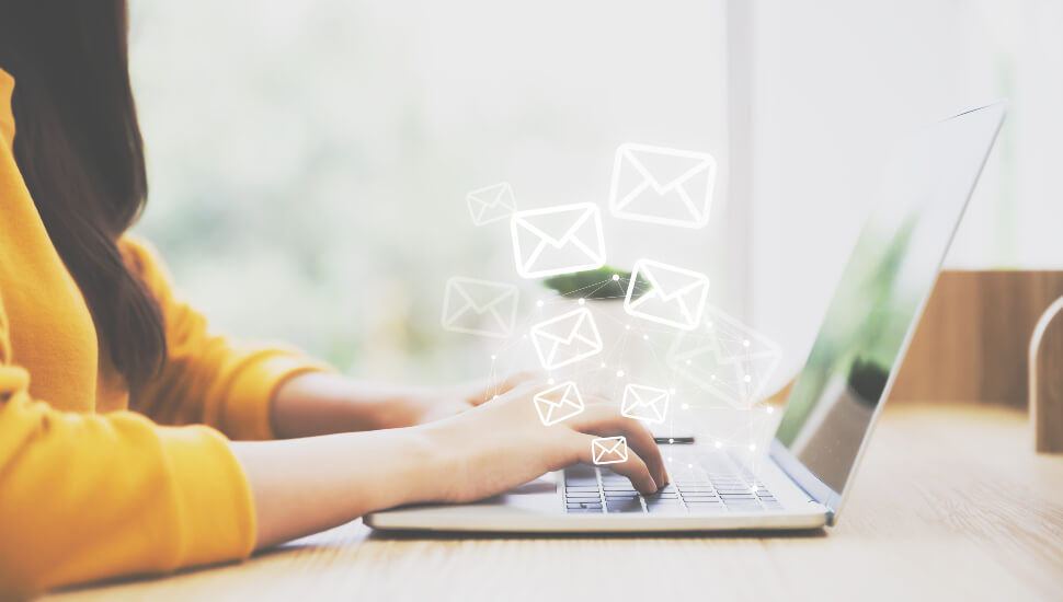 Woman responding to her emails on a laptop