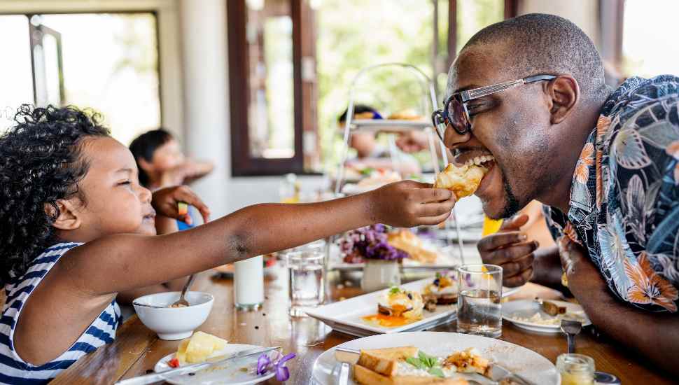 girl feeding man