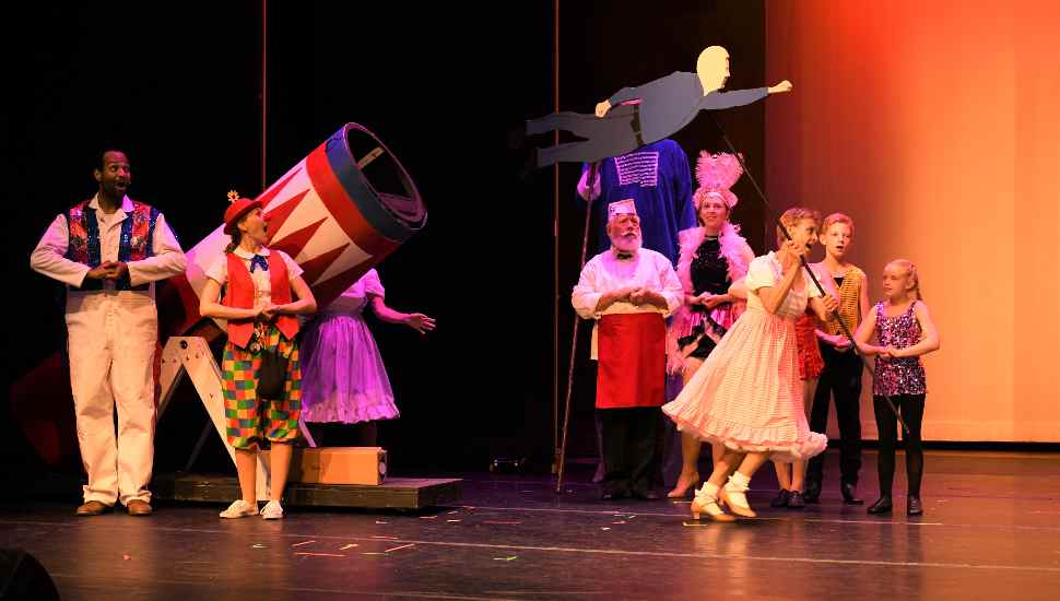 man flying across a stage