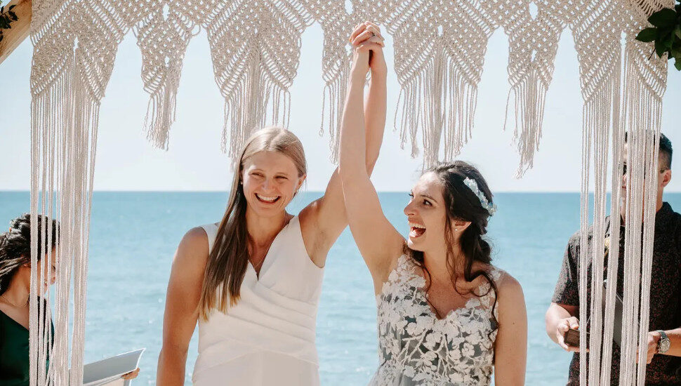 women with hands in the air