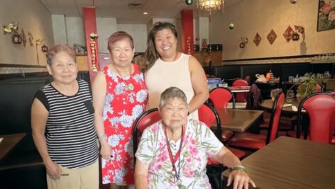 In the Golden Dragon dining room are June Wong (left) her sister, matriarch Lang Vuong (seated). At center is Vuong's daughter Susan Thuha Long, next to her daughter Jennifer Hua.