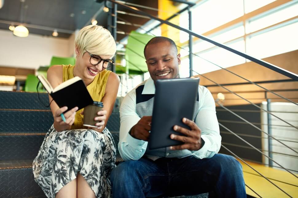 Man and woman enjoy an informal conversation at work