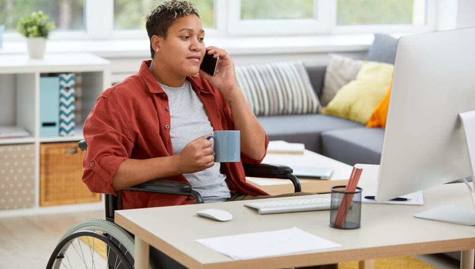 Woman in a wheelchair working remotely