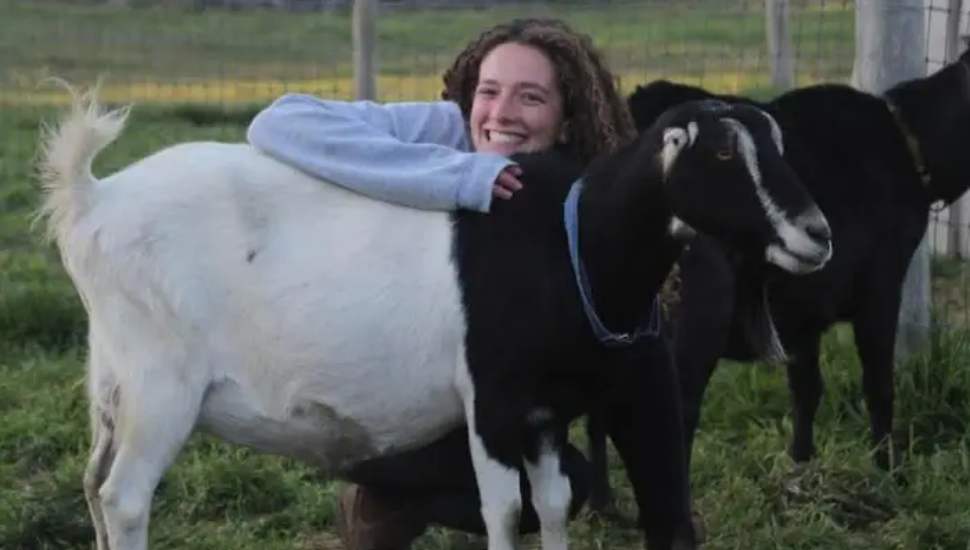 girl hugging goat