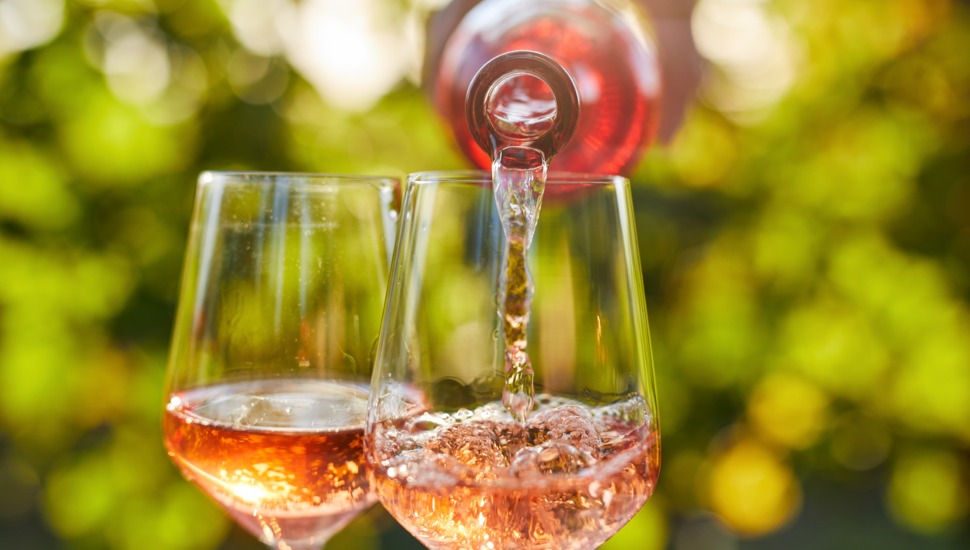 Pouring wine into two wine glasses