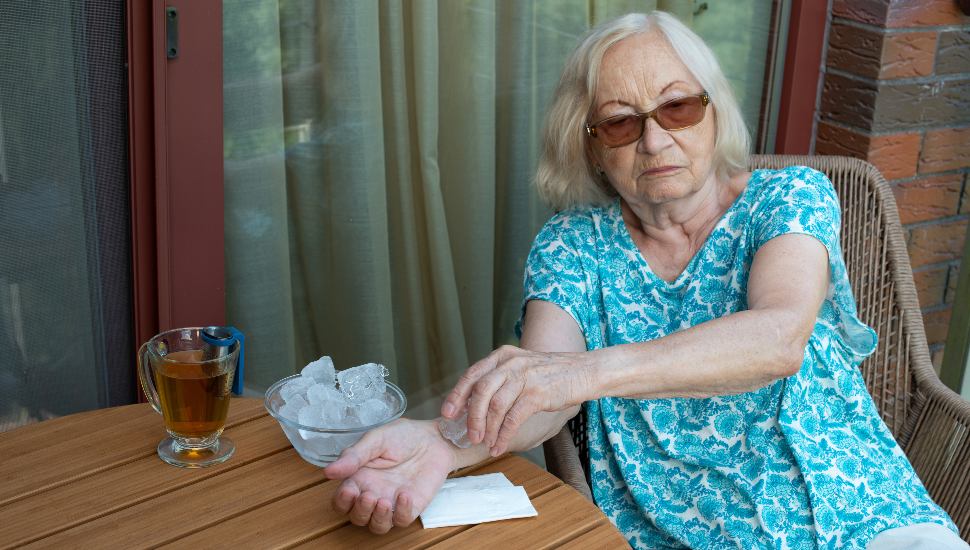 woman cooling down in heat advisory with ice cube on her wrist